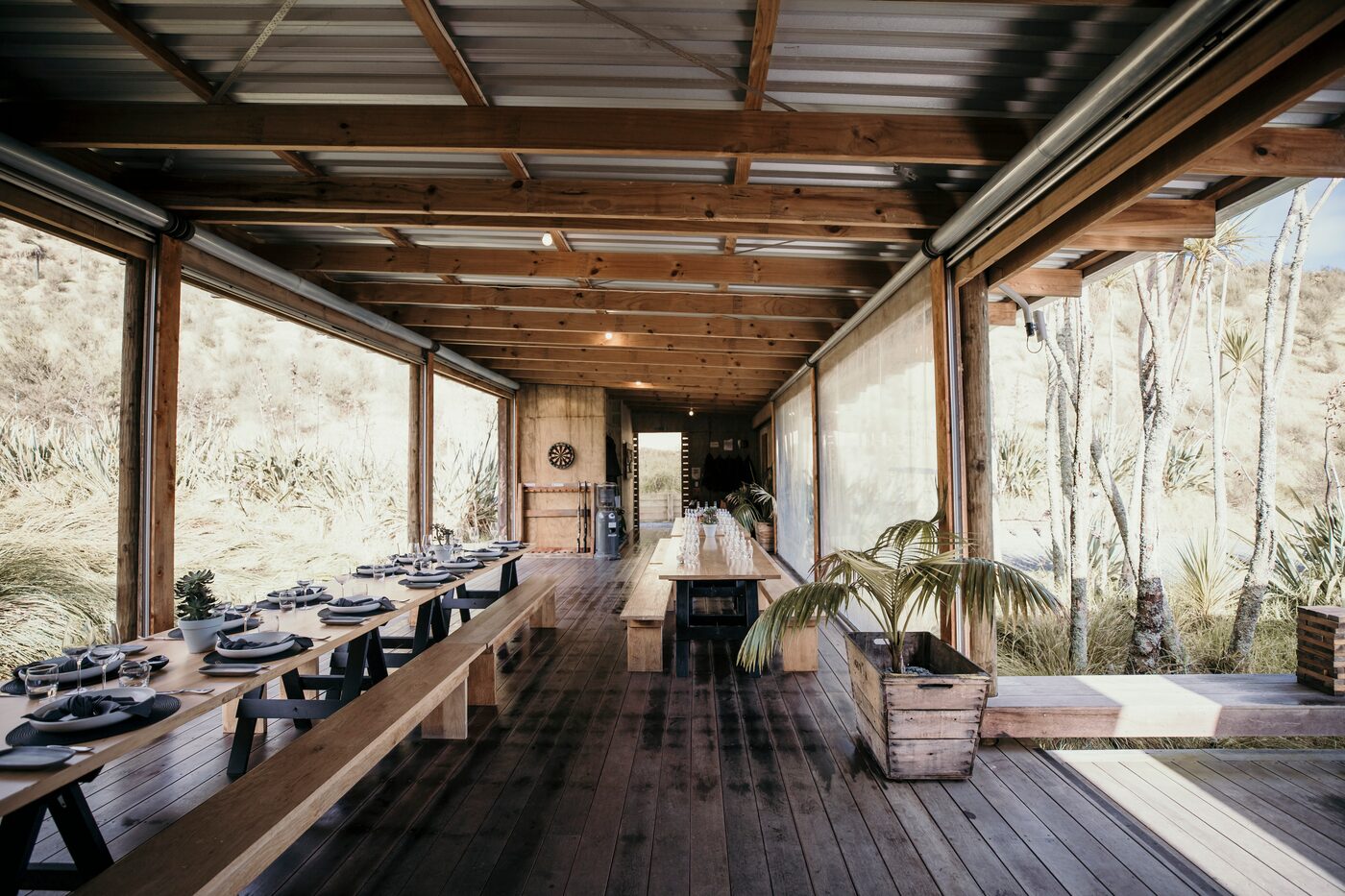 Long tables set for lunch inside The Bunkers, open to the native planting